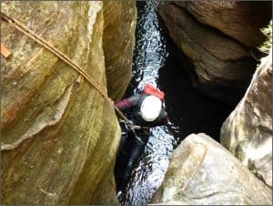 Scout abseiling down into water 